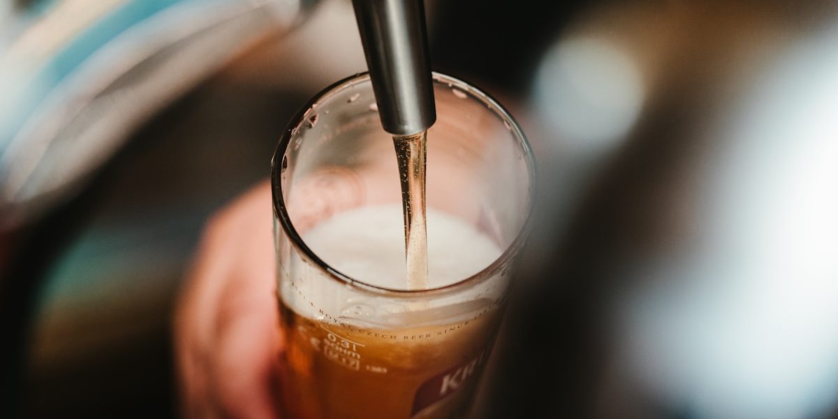 Golden beer in glasses with brewery background