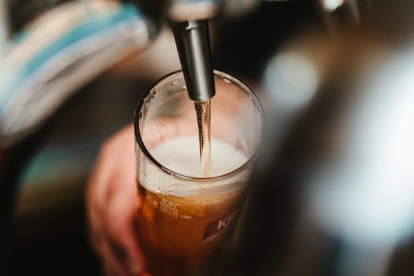 Golden beer in glasses with brewery background