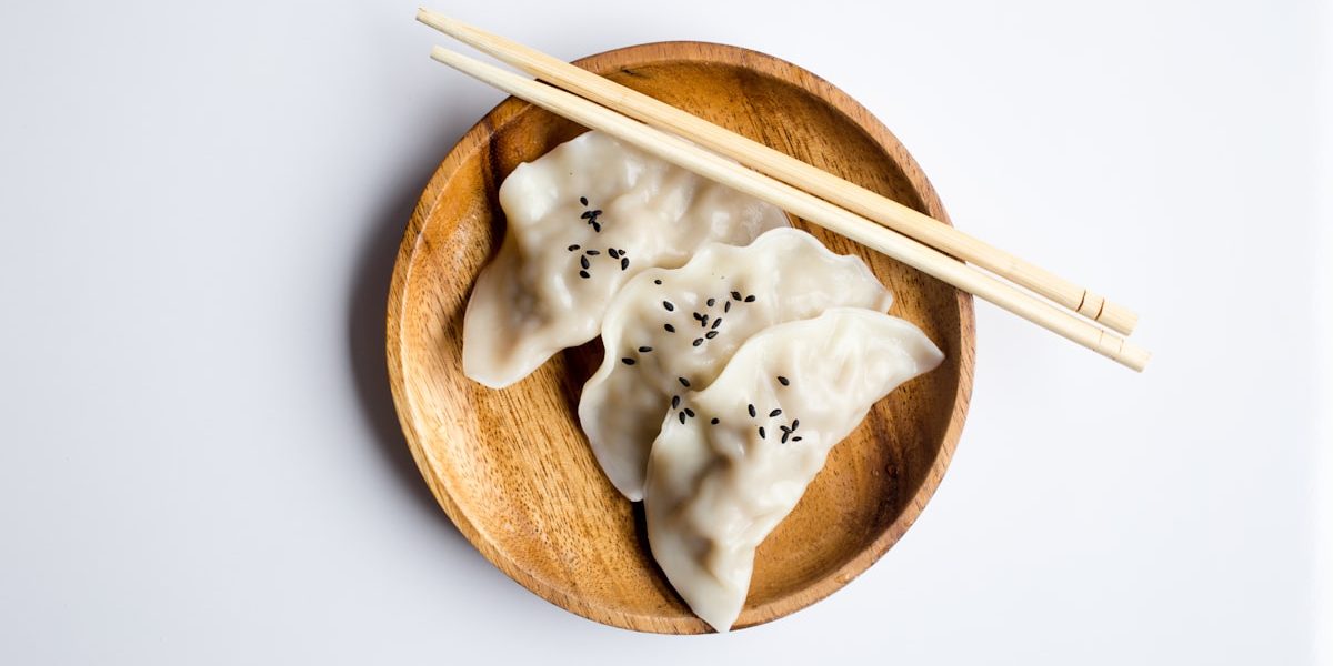 Steaming Chinese dumplings in bamboo steamer basket